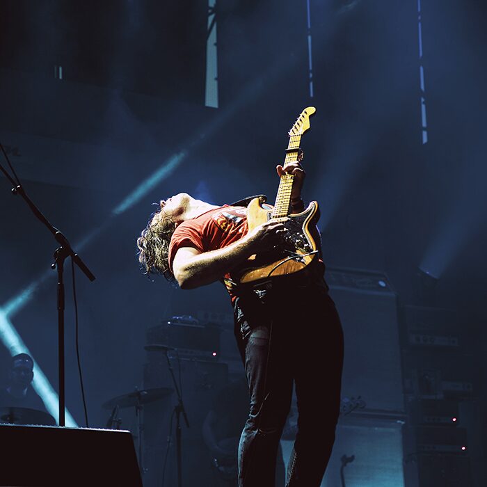 A focused live performance under stage lighting, reflecting team coordination and leadership practice